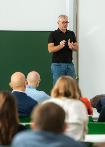 A lecturer explaining his data in front of the audience