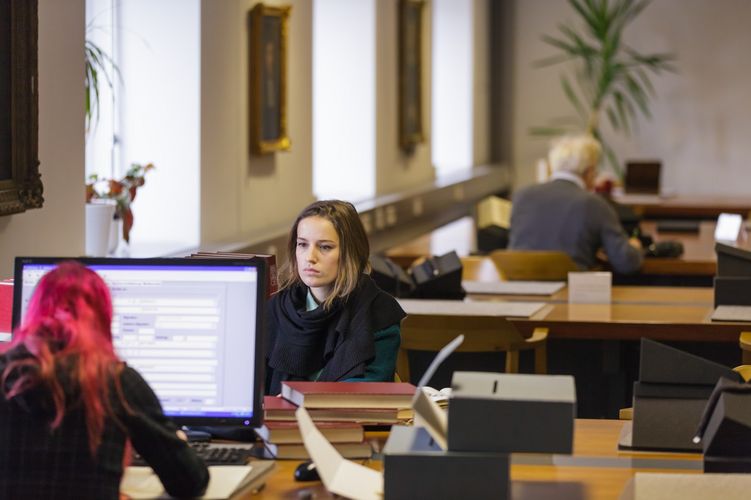 View of two students at the computer in the library