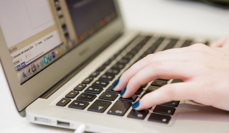 Foto: Hände auf der Tastatur eines Laptops