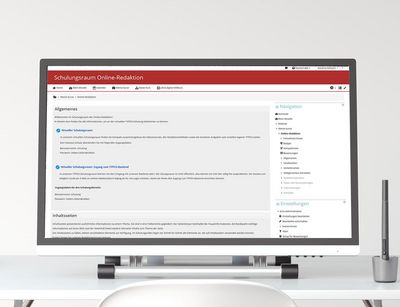 Auf einem Schreibtisch steht ein großer Computerbildschirm, der den Moodle-Kurs der Online-Redaktion anzeigt. anzeigt. 
