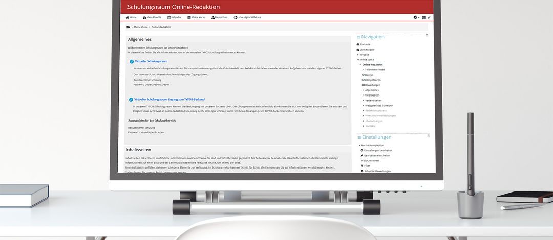 Auf einem Schreibtisch steht ein großer Computerbildschirm, der den Moodle-Kurs der Online-Redaktion anzeigt. anzeigt. 