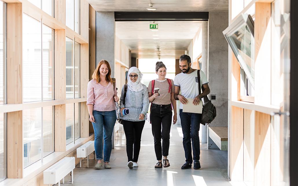 enlarge the image: Group of students walking through the corridor in the Humanities Centre