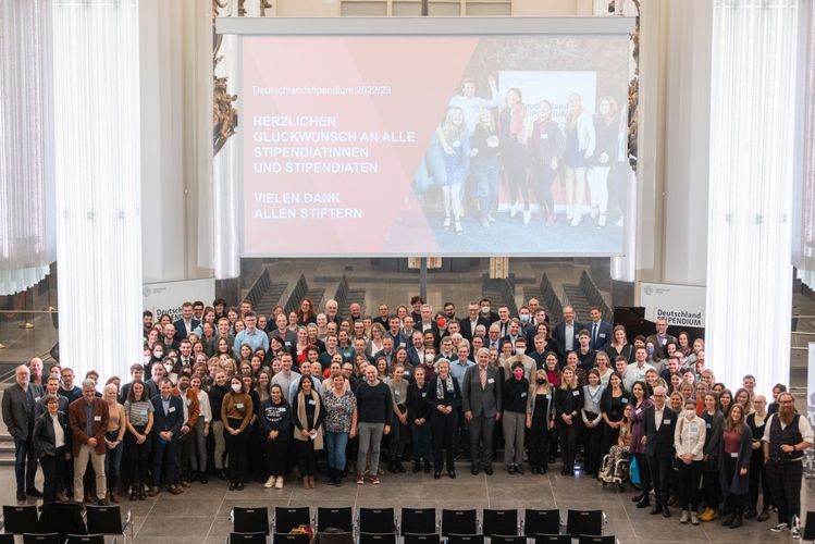 alle Stipendiaten und Förderer stehen auf der Bühne in der Aula im Paulinum und schauen hoch zum Fotografen für ein Gruppenbild