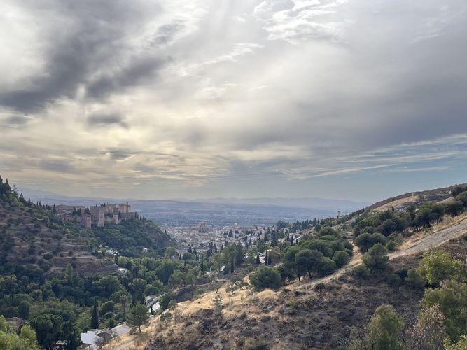 Weitschweifender Panoramablick auf die Stadt Granada mit der Alhambra links im Bild. 