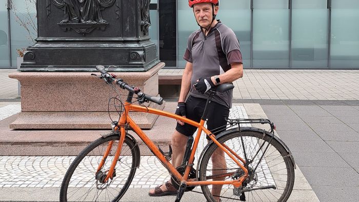 Zu sehen ist der gewinner der Einzelwertung der Uni beim Stadtradeln 2023 Rolf Kamieth, der hinter seinem Fahrrad steht.