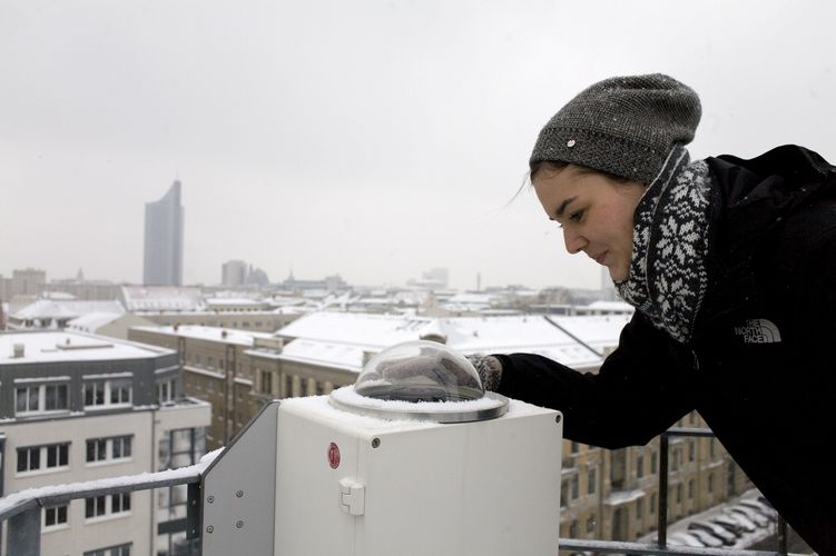 Student standing on a roof and it's winter