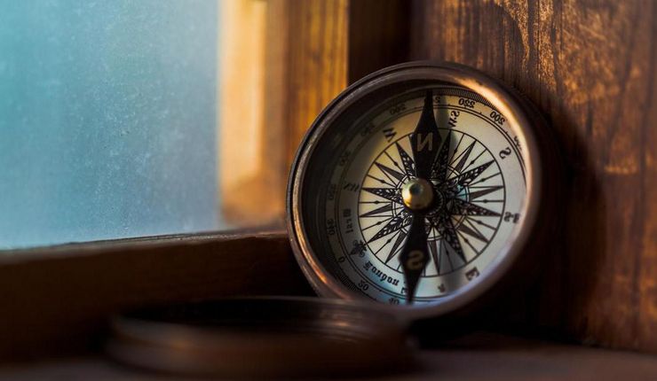 Compass next to a window.