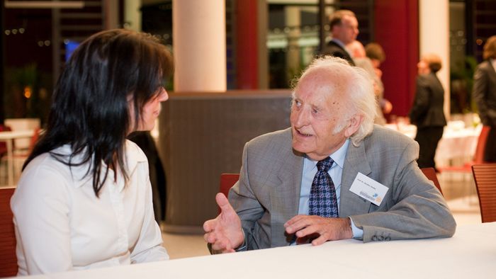 Das Bild zeigt Prof. Dr. Günther Sterba beim Alumnitreffen im Jahr 2009 im Gespräch mit einer Studentin. 