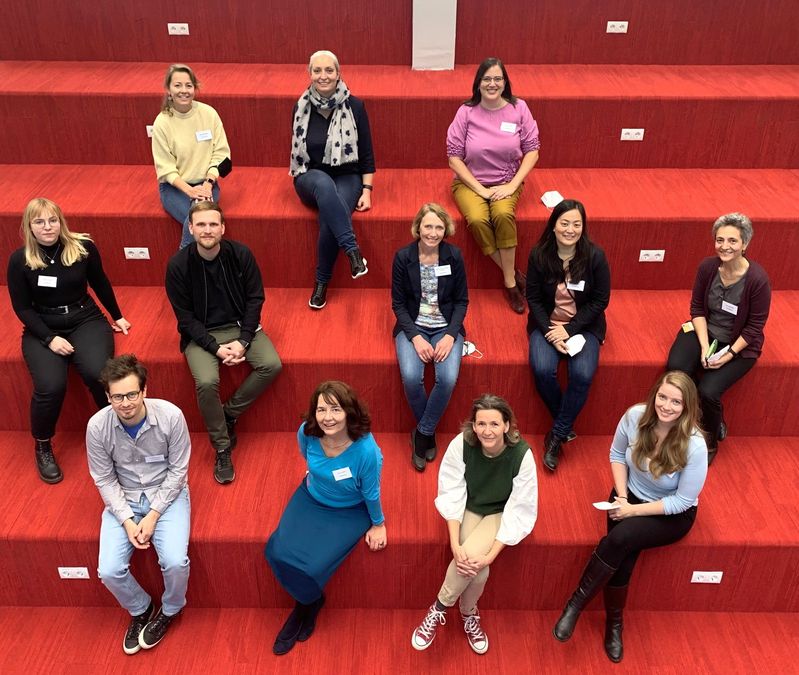 zur Vergrößerungsansicht des Bildes: ITEA-Gruppenmitglieder sitzen auf einer Treppe in der Universitätsbibliothek Graz