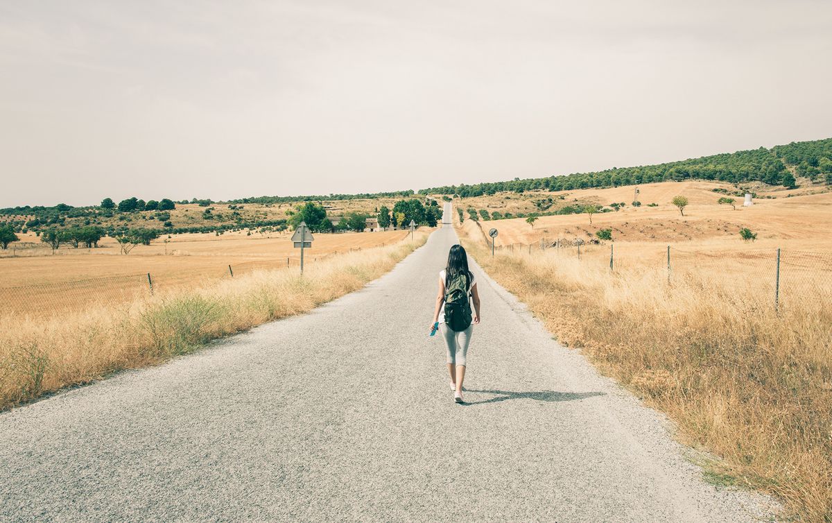 enlarge the image: Young woman walks along a path