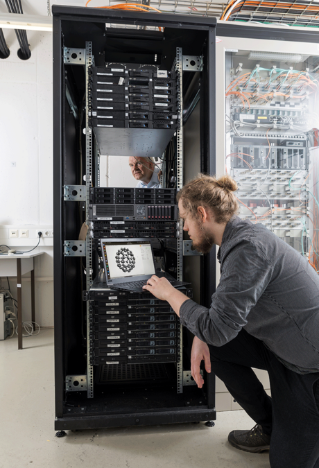 enlarge the image: Two scientist working in a server room